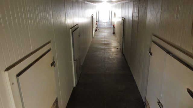 Panel-lined corridor with refrigerated doors